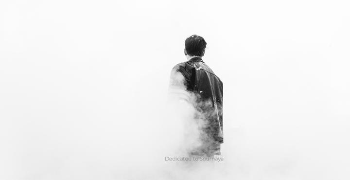 black and white photo of a male figure surrounded by fog